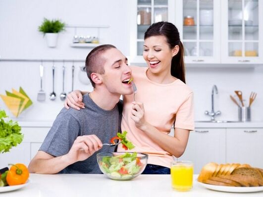 The girl feeds her husband with products to increase activity