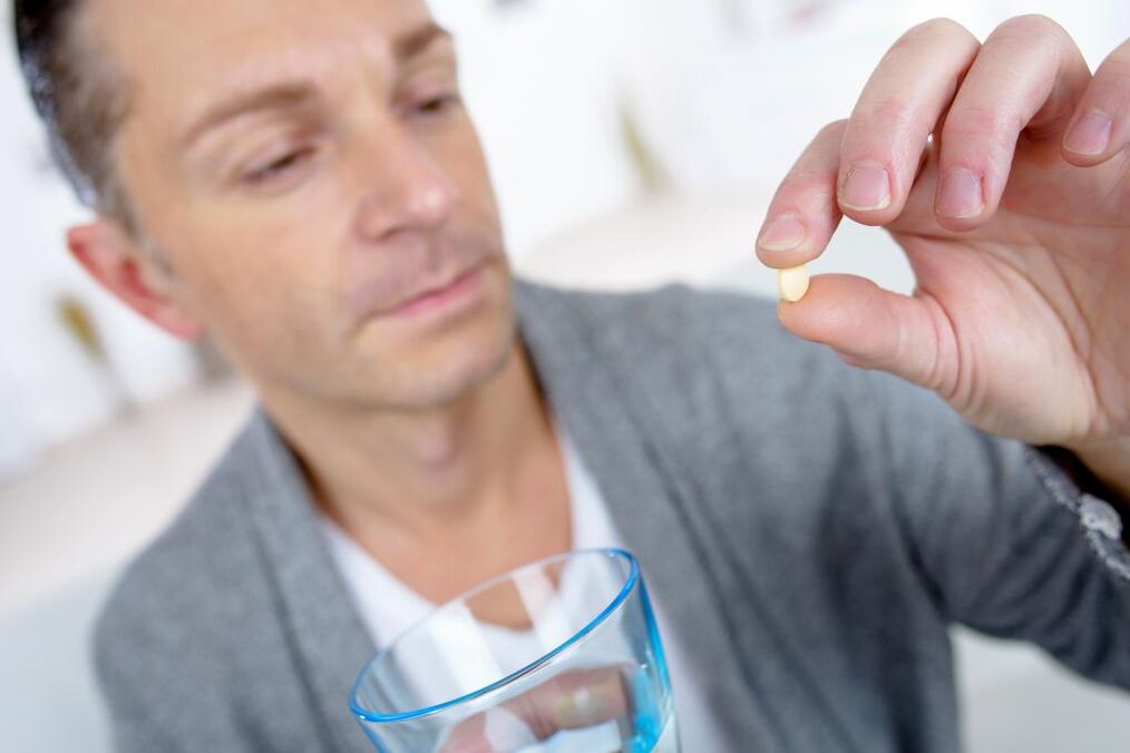 a man takes a pill to increase activity
